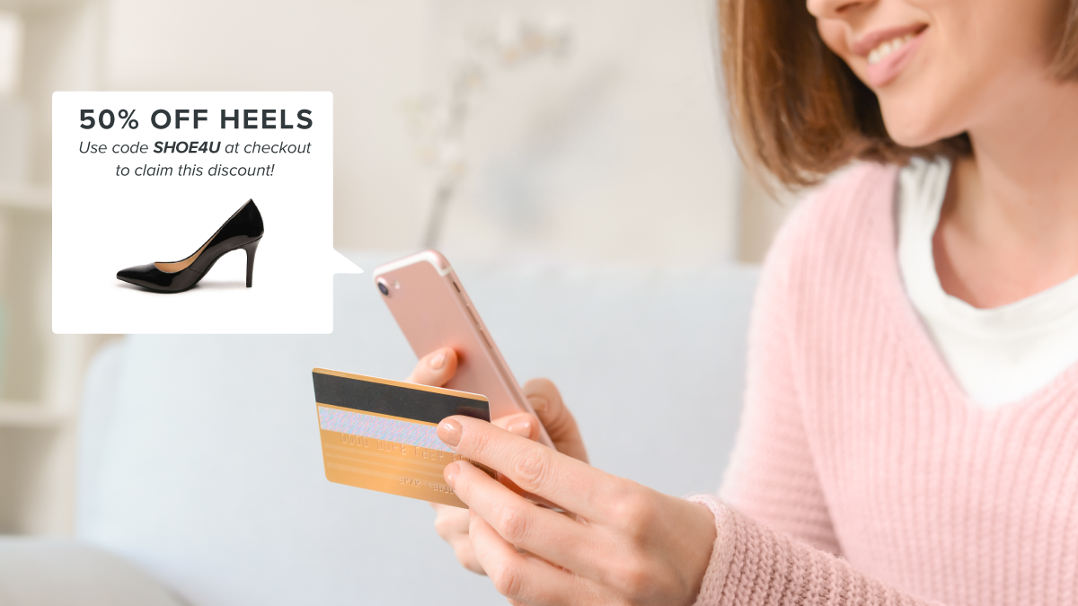 Woman with credit card in hand buying a set of heels with a coupon code