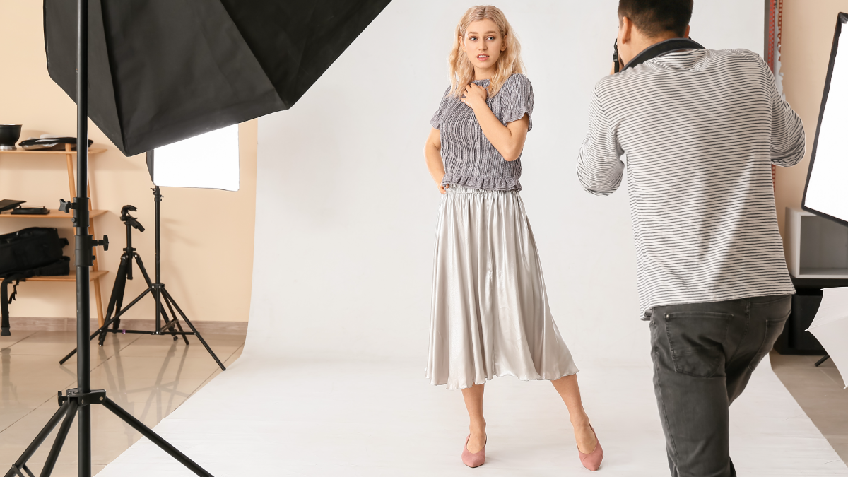 Woman modeling an outfit and being photographed for an ecommerce website.
