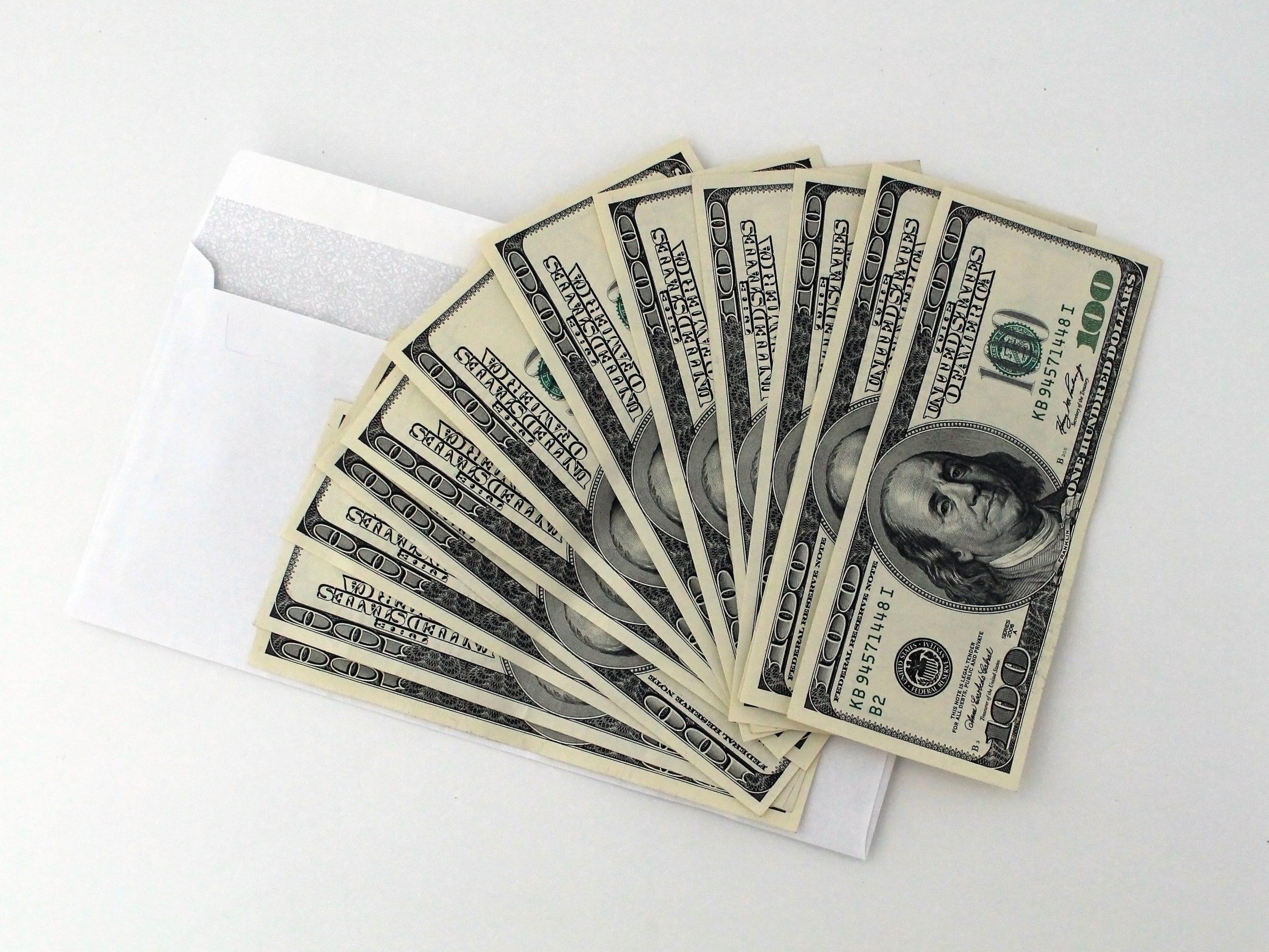 A stack of cash saved up when investing in software to automate your invoicing