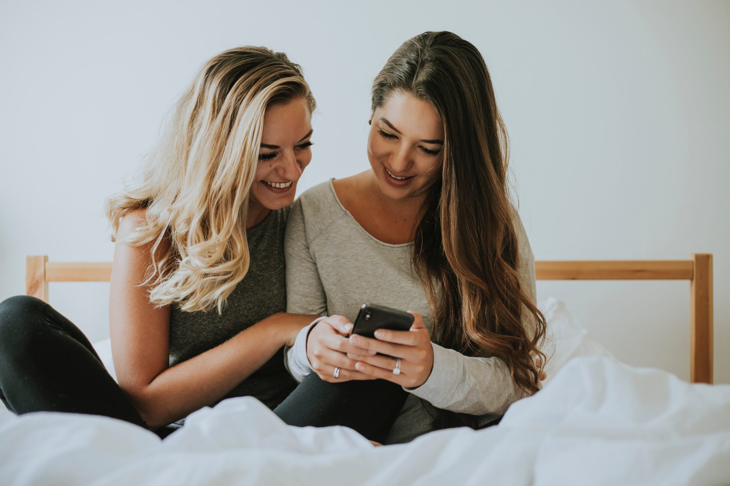 Woman sharing her newsfeed with her friend