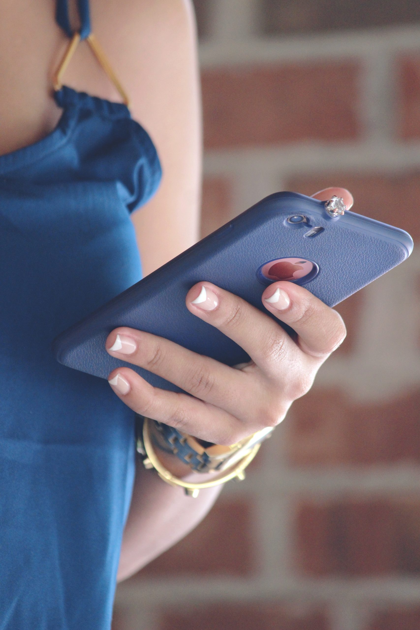 Upclose of woman holding her smartphone vertically in one hand