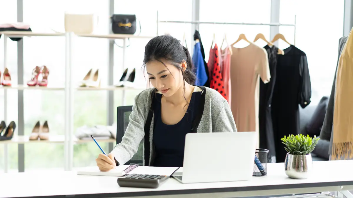 Women in retail store creating a plan for seasonal markdowns.